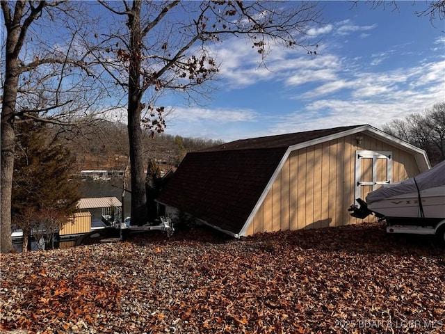 view of side of home featuring an outbuilding