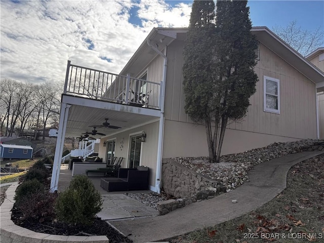 view of home's exterior with an outdoor hangout area, ceiling fan, a balcony, and a patio