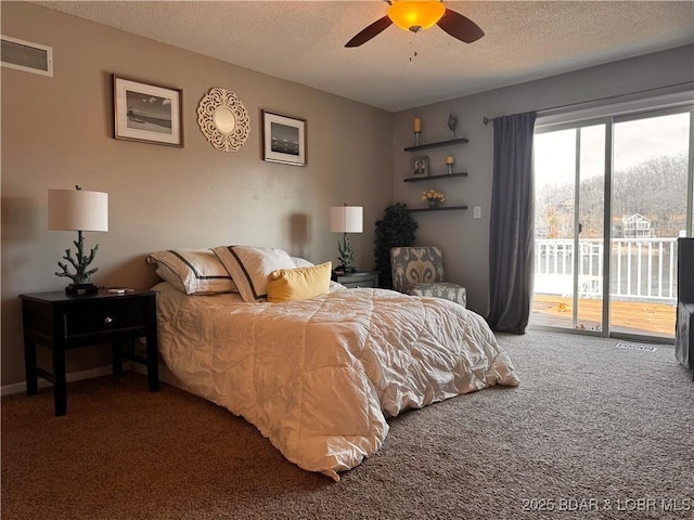 carpeted bedroom with access to exterior, visible vents, and a textured ceiling