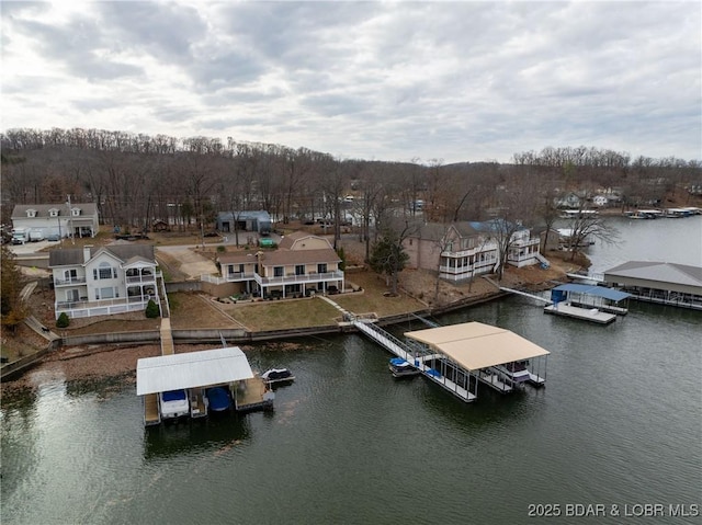 drone / aerial view featuring a water view and a residential view