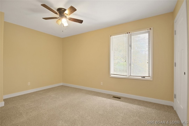 unfurnished room featuring ceiling fan, plenty of natural light, and carpet floors