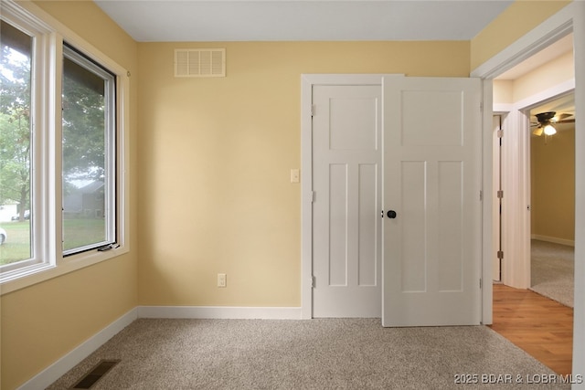 unfurnished bedroom with a closet and carpet