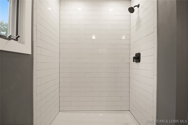 bathroom with tiled shower