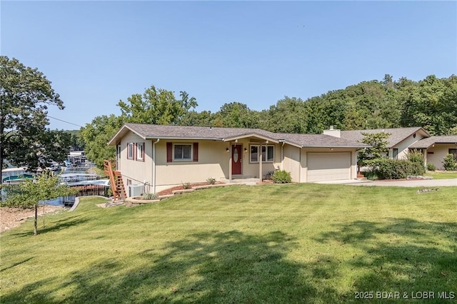 ranch-style home featuring central air condition unit, a front lawn, and a garage