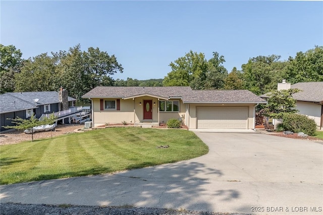 single story home featuring a garage and a front lawn