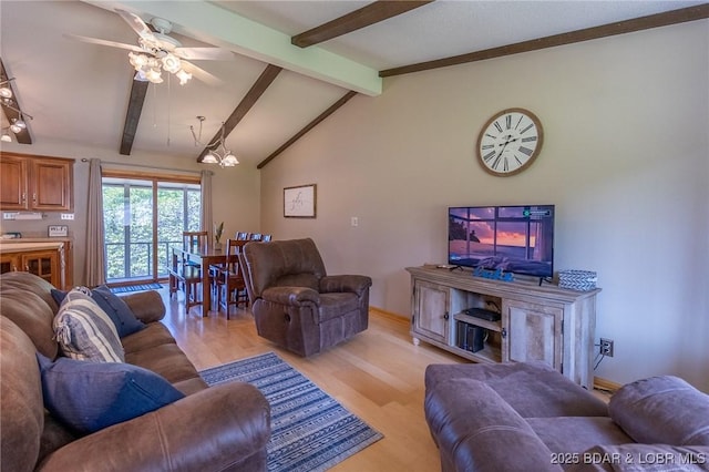 living room with vaulted ceiling with beams, ceiling fan, and light hardwood / wood-style flooring