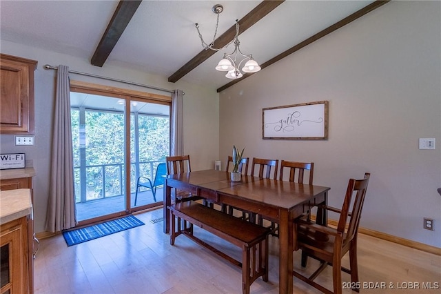 dining area with vaulted ceiling with beams, light wood-type flooring, and an inviting chandelier