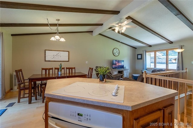 interior space featuring vaulted ceiling with beams, ceiling fan with notable chandelier, and light wood-type flooring