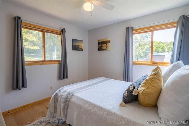 bedroom with hardwood / wood-style flooring and ceiling fan