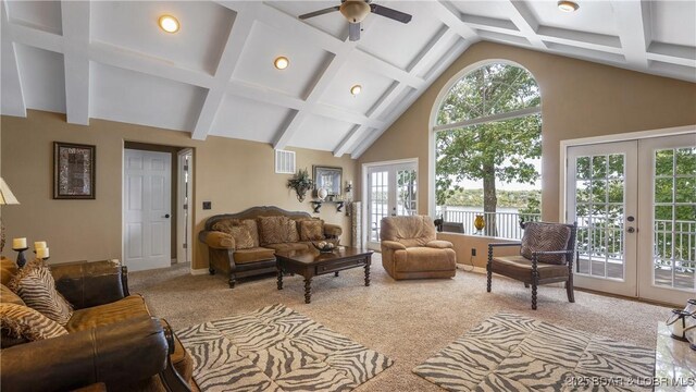 sunroom with plenty of natural light, ceiling fan, vaulted ceiling, and french doors