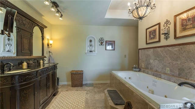 bathroom featuring tiled bath, tile patterned flooring, vanity, and an inviting chandelier