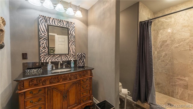 bathroom with vanity, toilet, and walk in shower