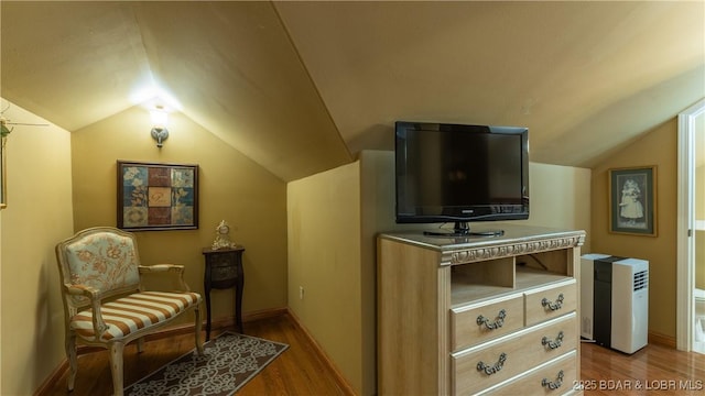 sitting room featuring light hardwood / wood-style flooring and lofted ceiling