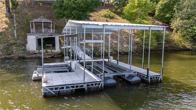 view of dock with a gazebo and a water view