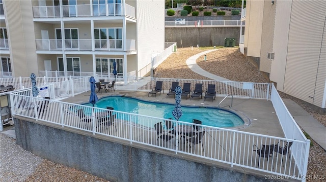 view of pool featuring central AC unit and a patio