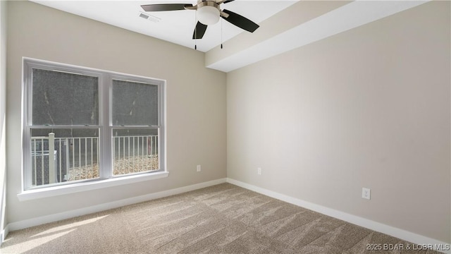 carpeted spare room with ceiling fan