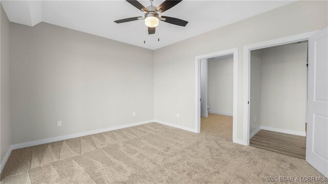 unfurnished bedroom featuring light colored carpet and ceiling fan