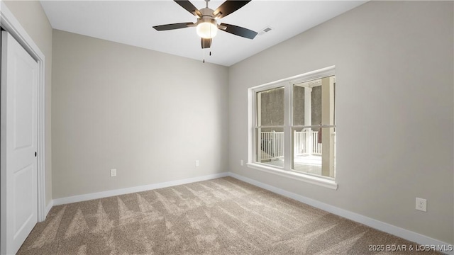 unfurnished room featuring carpet floors and ceiling fan