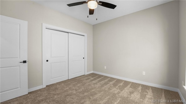 unfurnished bedroom featuring ceiling fan, carpet flooring, and a closet