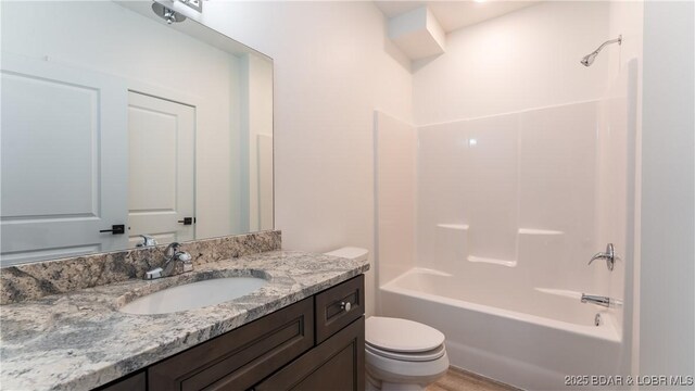 full bathroom with shower / washtub combination, vanity, and toilet