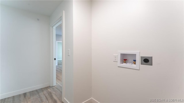 laundry area featuring hookup for an electric dryer, light hardwood / wood-style floors, and hookup for a washing machine