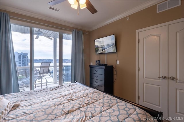 bedroom featuring ceiling fan, a closet, and crown molding