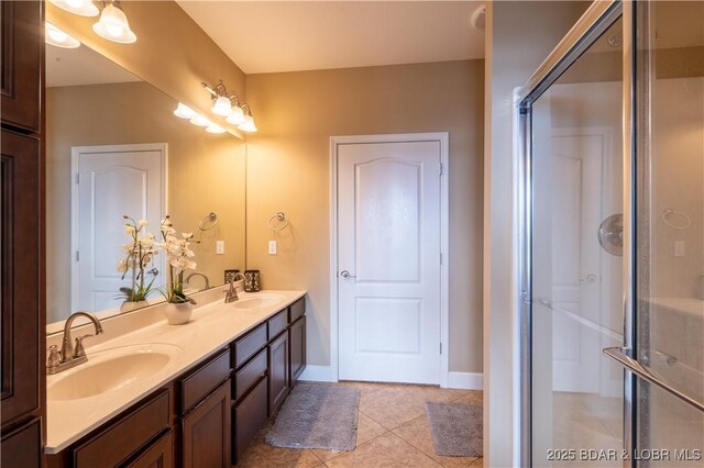 bathroom with tile patterned floors, vanity, and walk in shower