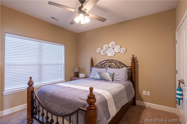 carpeted bedroom featuring multiple windows and ceiling fan