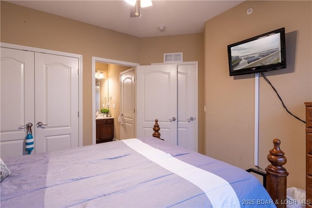 bedroom featuring ensuite bathroom and a closet