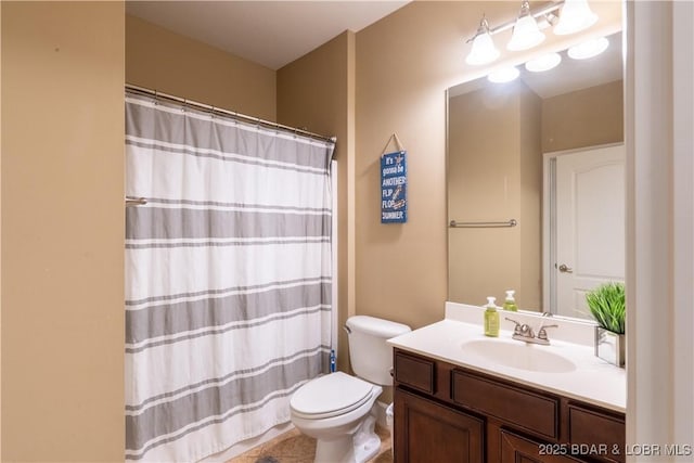 bathroom with a shower with shower curtain, vanity, and toilet