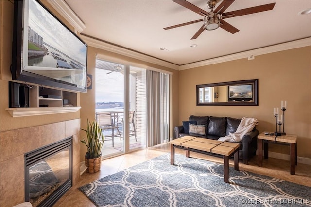 living room featuring a fireplace, ceiling fan, and crown molding