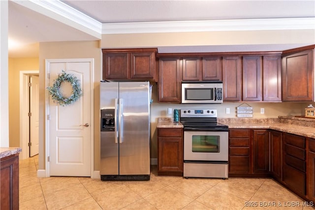 kitchen with light stone counters, light tile patterned floors, stainless steel appliances, and ornamental molding