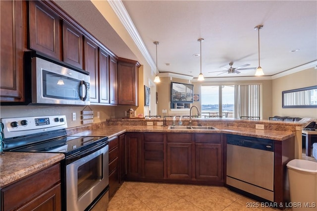 kitchen with pendant lighting, sink, ceiling fan, appliances with stainless steel finishes, and kitchen peninsula