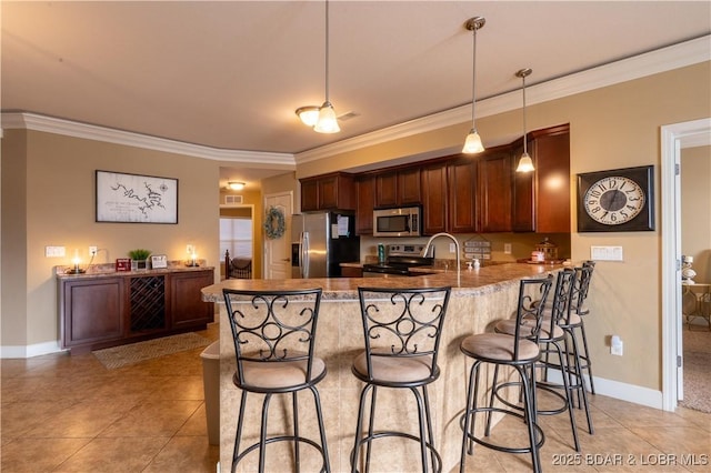 kitchen with decorative light fixtures, a kitchen bar, kitchen peninsula, and appliances with stainless steel finishes