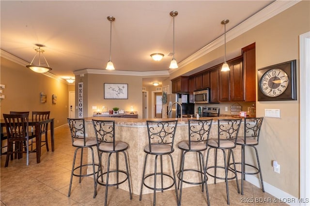 kitchen featuring ornamental molding, light tile patterned floors, decorative light fixtures, kitchen peninsula, and stainless steel appliances