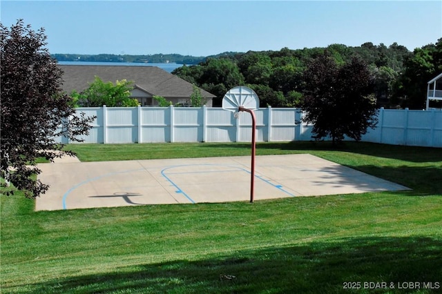 view of basketball court with a lawn