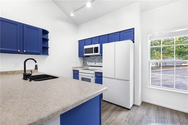 kitchen with sink, white appliances, blue cabinets, and light hardwood / wood-style flooring