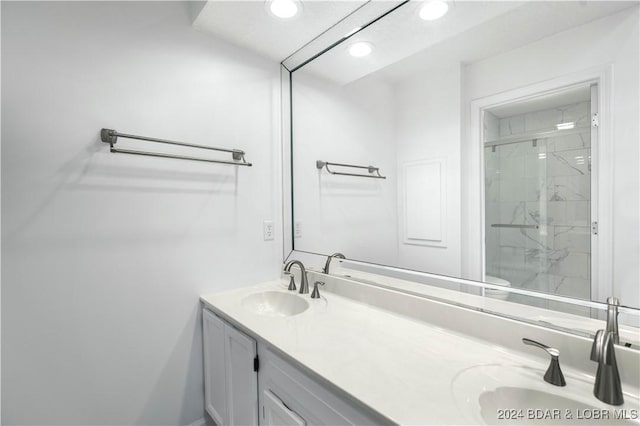 bathroom with a shower with door and vanity