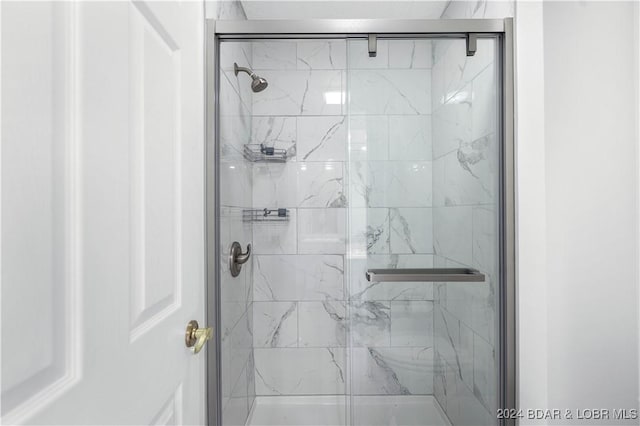 bathroom featuring a shower with door