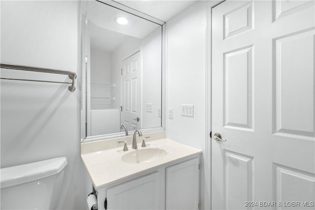 bathroom featuring vanity and toilet