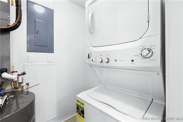 washroom with electric panel and stacked washer and dryer