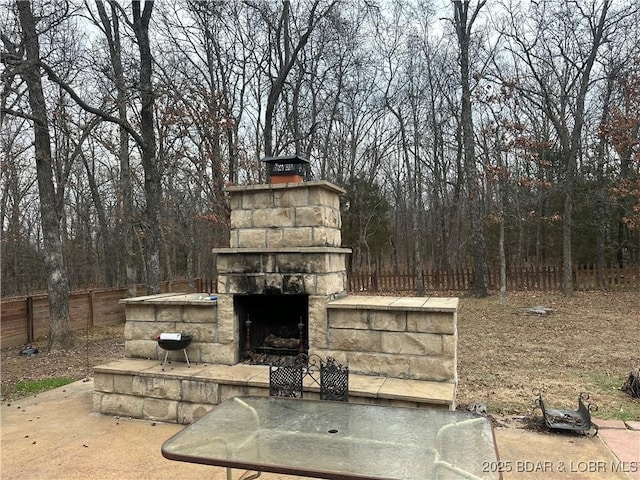 view of patio with an outdoor stone fireplace