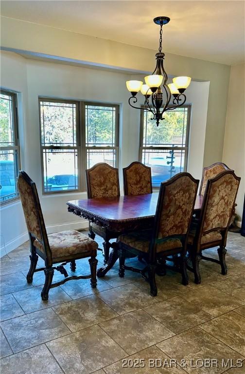 dining space featuring a notable chandelier