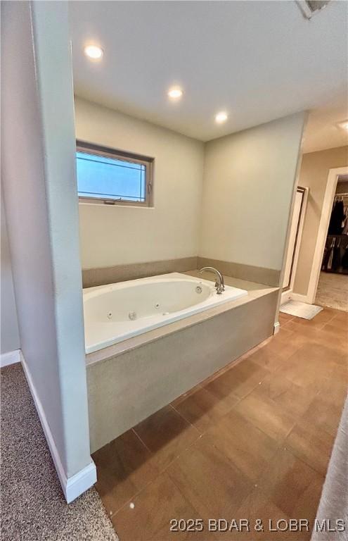 bathroom featuring tile patterned flooring and a washtub