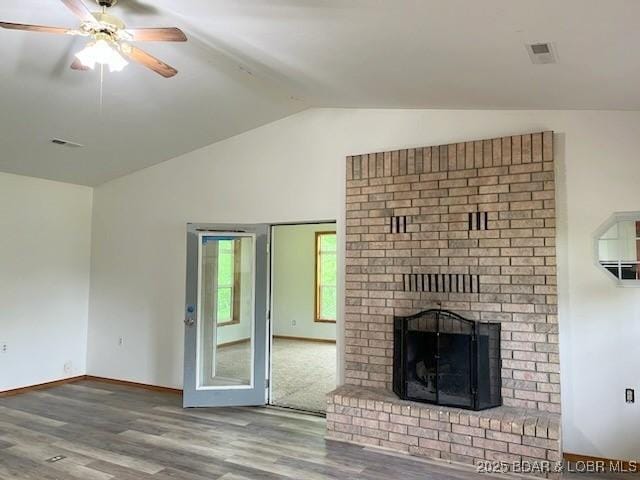 unfurnished living room with a fireplace, hardwood / wood-style flooring, ceiling fan, and lofted ceiling