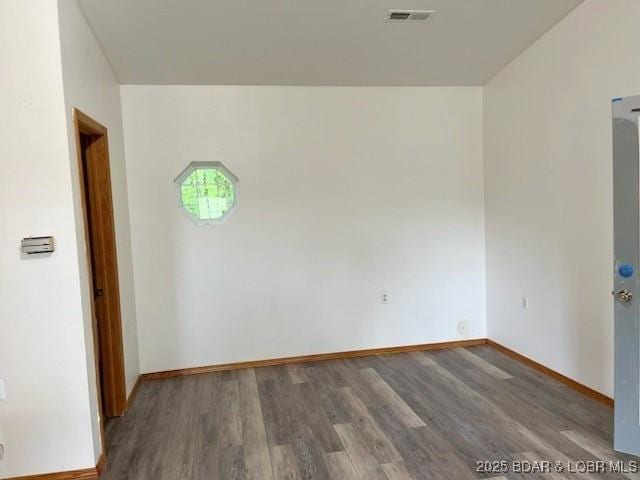 spare room with dark hardwood / wood-style floors