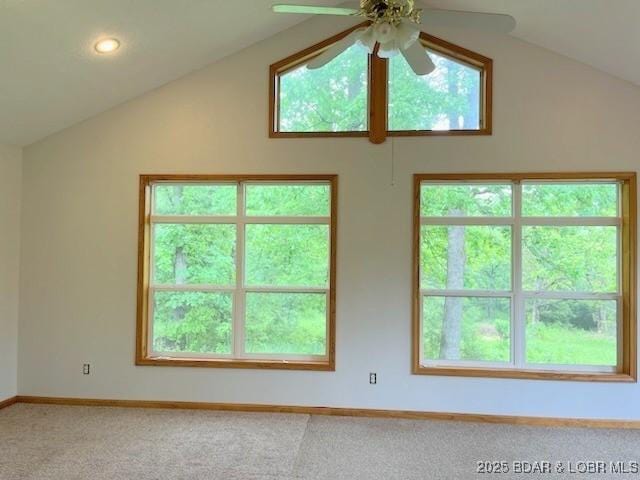 carpeted spare room with ceiling fan and lofted ceiling