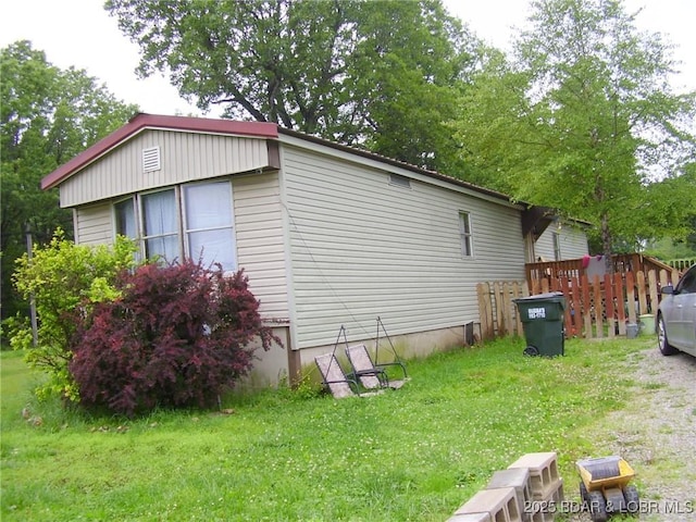 view of home's exterior with a yard