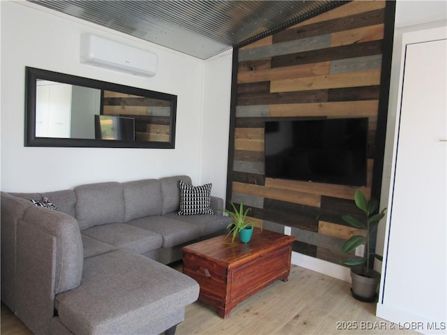 living room featuring wood walls, an AC wall unit, and wood finished floors