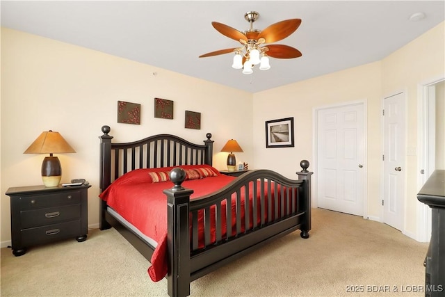 carpeted bedroom featuring ceiling fan and baseboards